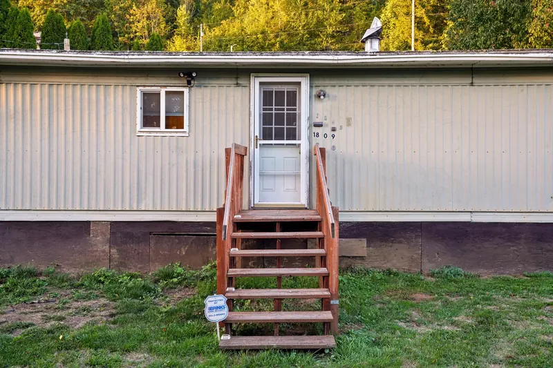 Single-wide mobile home with front steps after setup and installation